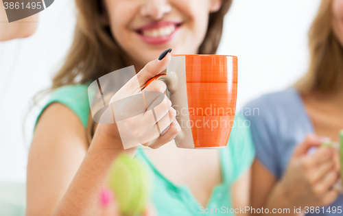 Image of happy woman or teen girl drinking tea from cup