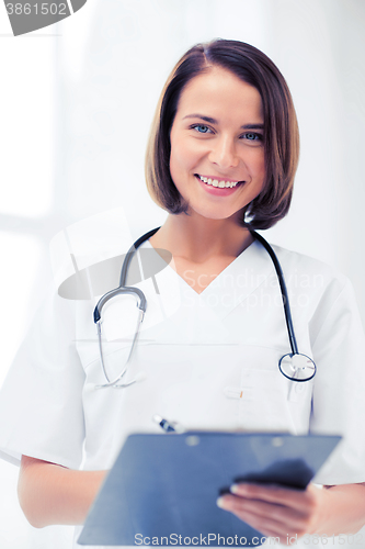 Image of doctor with stethoscope writing prescription