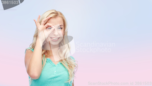 Image of young woman making ok hand gesture