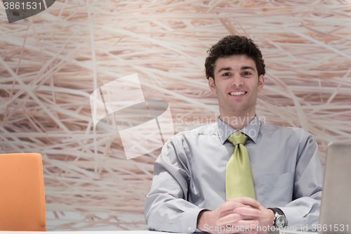 Image of young business man  working on laptop  computer at modern office