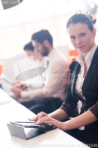 Image of business woman on meeting  using tablet