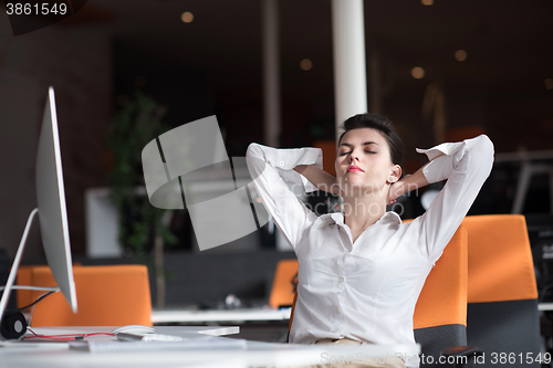 Image of happy young business woman relaxing and geting insiration