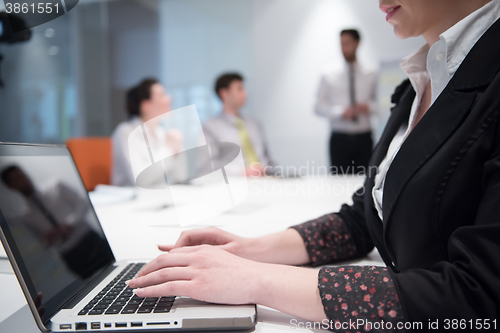 Image of young business woman on meeting  using laptop computer