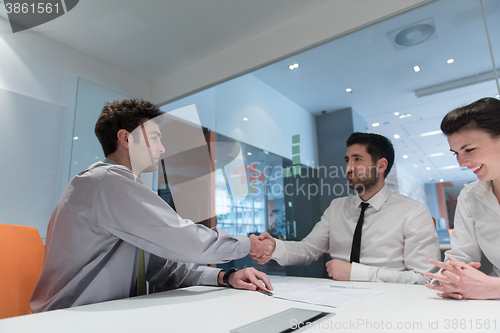 Image of young couple signing contract documents on partners back