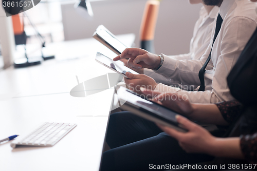 Image of business people on meeting  using tablet