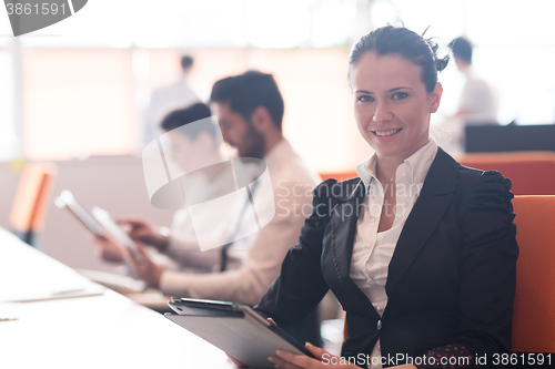 Image of business woman on meeting  using tablet