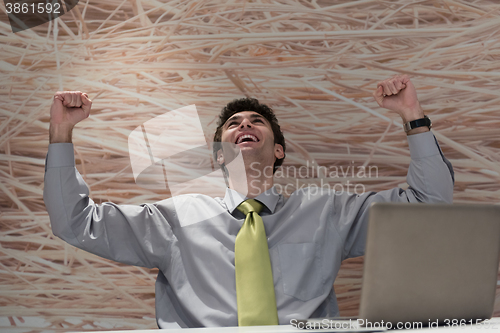 Image of young business man  working on laptop  computer at modern office