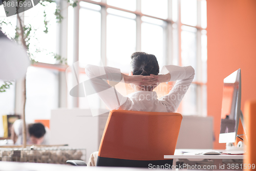 Image of happy young business woman relaxing and geting insiration