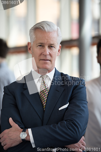 Image of portrait of handsome senior business man at modern office