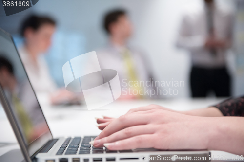 Image of woman hands typing on laptop keyboard at business meeting