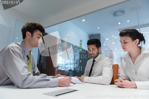 Image of young couple signing contract documents on partners back