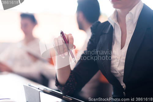 Image of woman hands holding pen on business meeting