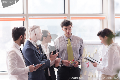 Image of young startup businessman making presentation to senior investio