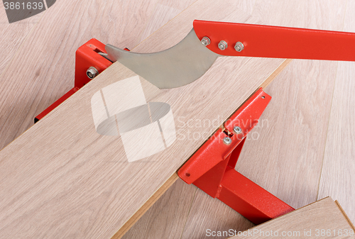 Image of Red tool for cutting laminate