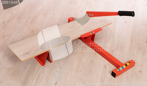 Image of Red tool for cutting laminate