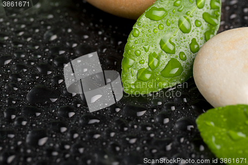 Image of zen stones on black with water drops