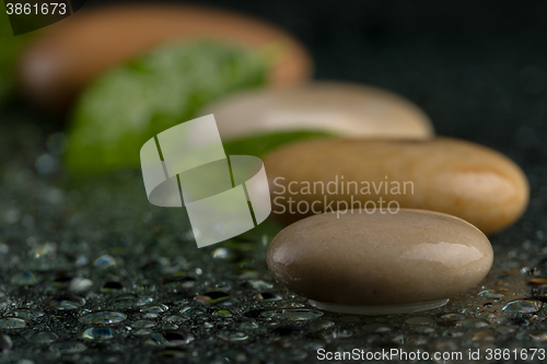 Image of zen stones on black with water drops