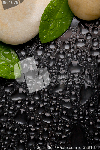 Image of zen stones on black with water drops