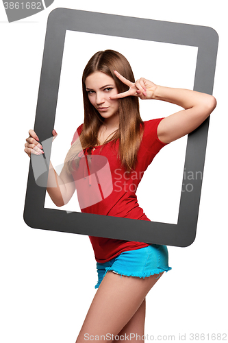 Image of Female looking through the frame giving thumb up