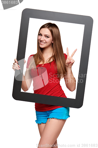 Image of Female looking through the frame giving thumb up