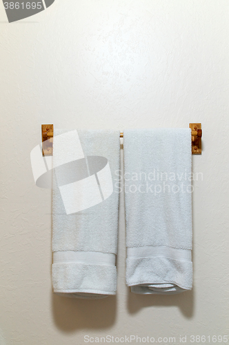 Image of Two white towels on wall