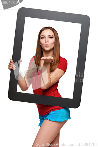 Image of Female looking through the frame blowing a kiss