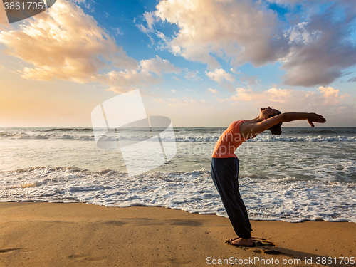 Image of Woman doing yoga Sun salutation Surya Namaskar 