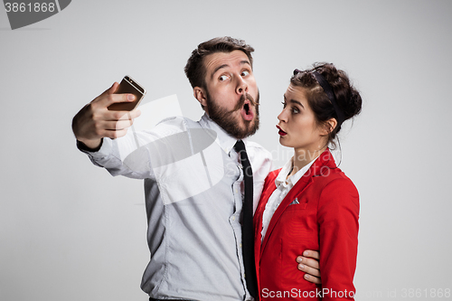 Image of Two colleagues friends taking selfie with telephone camera 