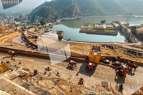 Image of Tourists riding elephants on ascend to Amer fort