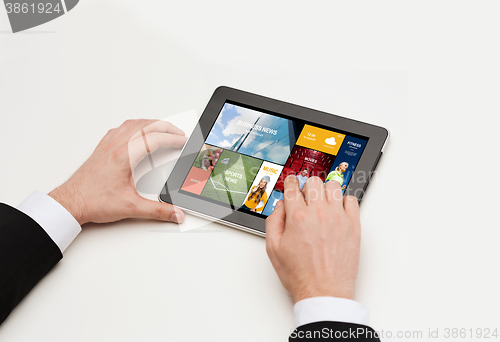 Image of close up of man hands with web pages on tablet pc