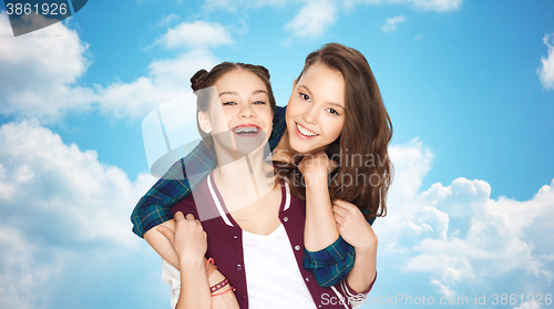 Image of happy smiling pretty teenage girls hugging