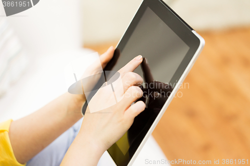 Image of close up of woman hand with tablet pc at home