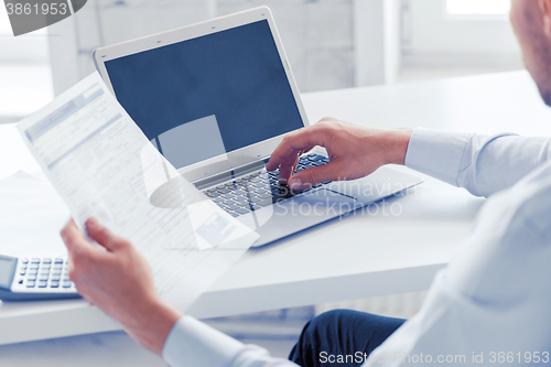 Image of miling businessman working in office