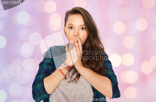 Image of scared teenage girl over pink holidays lights