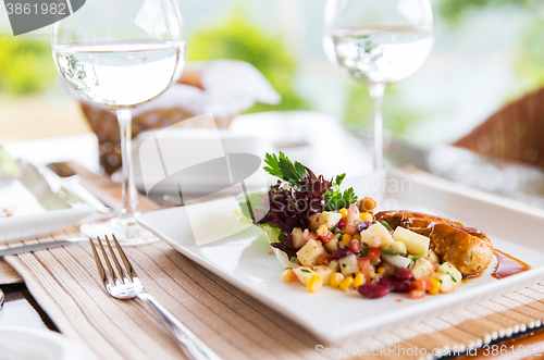 Image of close up of food and water glasses at restaurant