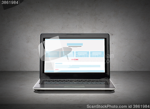 Image of laptop computer with web design template on screen