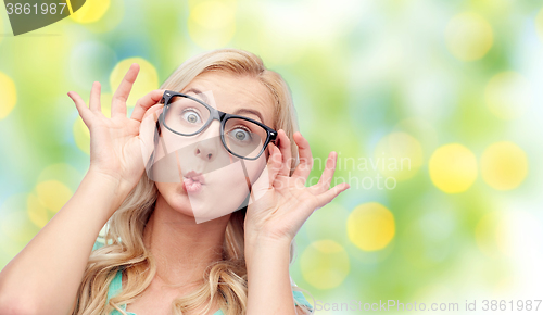 Image of happy young woman in glasses making fish face