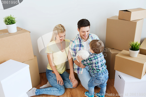 Image of happy family moving to new home and playing ball