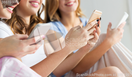 Image of friends or teen girls with smartphones at home