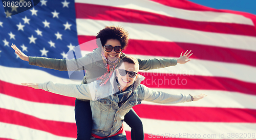 Image of happy multiracial couple over american flag