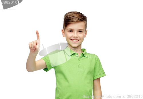 Image of happy boy in green polo t-shirt pointing finger up