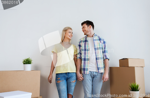 Image of smiling couple with big boxes moving to new home