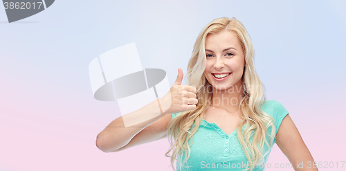 Image of happy woman or teenage girl showing thumbs up