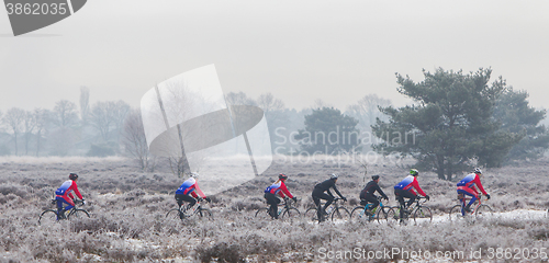 Image of EPE, THE NETHERLANDS - MARCH 5, 2016: Cyclists under winter skie