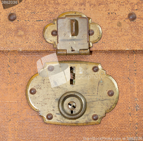 Image of Old canvas trunk lock close up