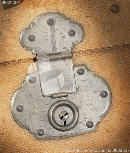 Image of Old canvas trunk lock close up