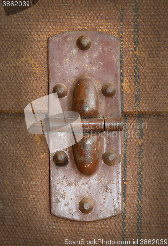 Image of Old canvas trunk hinge close up