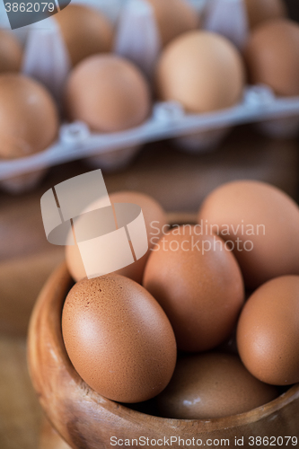 Image of Fresh eggs at wooden plate 