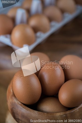 Image of Fresh eggs at wooden plate 