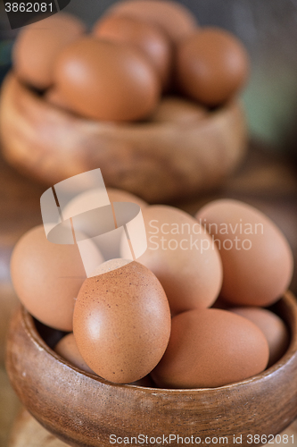 Image of Fresh eggs at wooden plate 